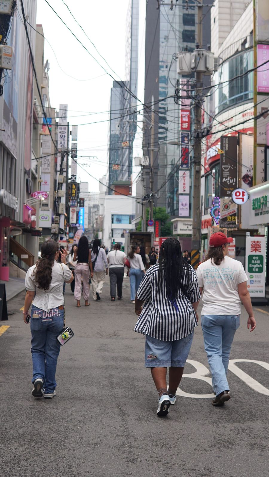 Students walking a Seoul shopping street